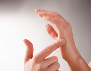 A woman demonstrating the chop points on hands that we rub as a part of the Emotional empowerment technique