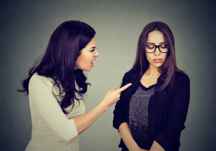 A woman shouting in anger at another girl