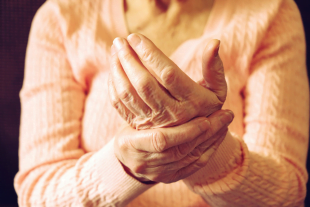 A man having pains in hand due to psychosomatic issues