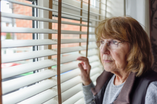 Women looking outside window wondering what is the defense mechanism of sublimation