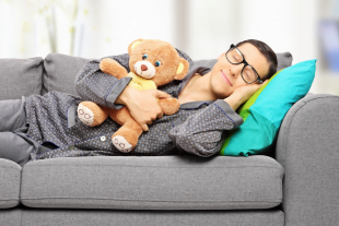 Raj exhibiting defense mechanism of regression as he sleeps with a teddy bear