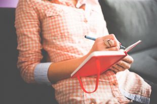 Woman journaling her activities to effectively plan for creating work life balance